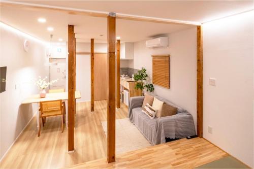 a living room with a couch and a table in a room at Room Inn Lu Lu Lu 横浜中華街 Room1-A in Yokohama