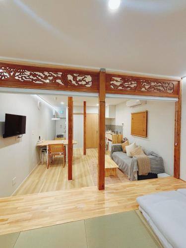 a living room with a couch and a table at Room Inn Lu Lu Lu 横浜中華街 Room1-A in Yokohama