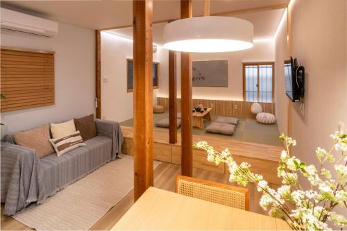a living room with a couch and a table at Room Inn Lu Lu Lu 横浜中華街 Room1-A in Yokohama