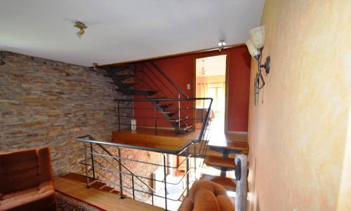 a staircase in a room with a brick wall at La Grange in Rochehaut