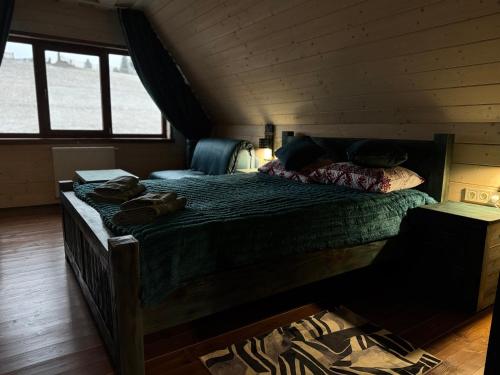 a bedroom with a large bed in a cabin at Spadok Forest Villas - Villa 2 in Sloboda