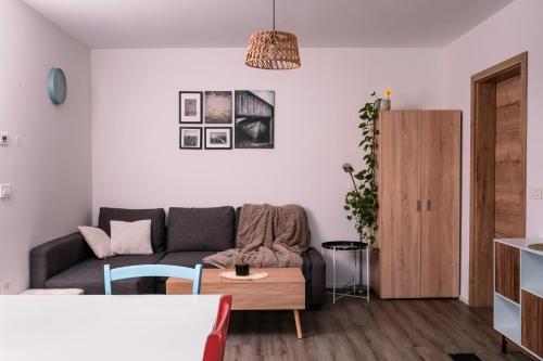 a living room with a couch and a table at Apartma Dreamscape in Radovljica