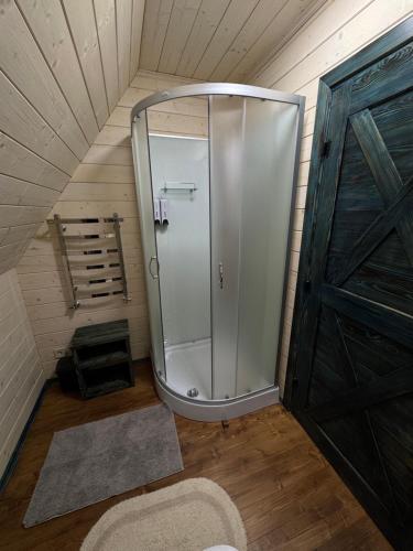 a walk in shower in a room with a door at Spadok Forest Villas - Villa 2 in Sloboda