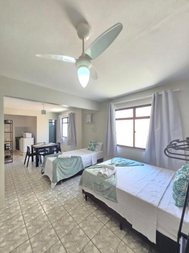een slaapkamer met twee bedden en een plafondventilator bij Loft Recanto Dos Cavalheiros! Com Ar Condicionado! in Macaé