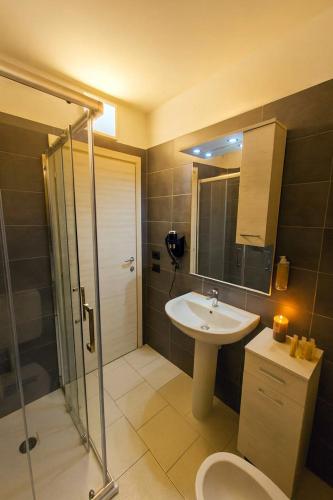 a bathroom with a shower and a sink and a toilet at The Park Hotel in Fanano