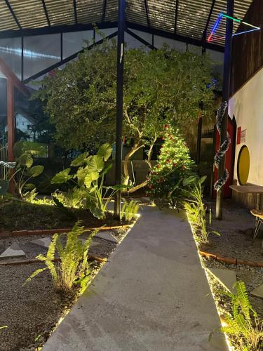 a garden path in a building with plants at Nhà Lười Homestay in Hue