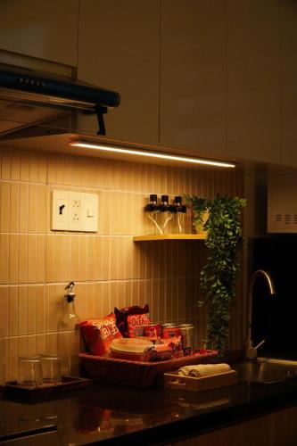 a kitchen with a counter with food on a shelf at BaBô Homestay Da Nang in Danang