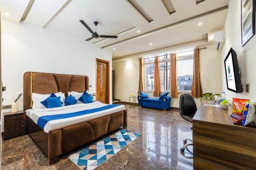 a bedroom with a bed with blue pillows at Bnb Sakura , Golf Course Road in Gurgaon