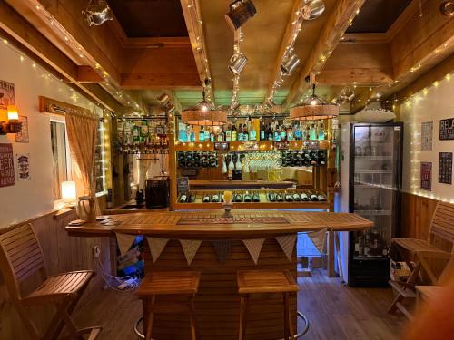 a bar in a restaurant with a lot of bottles at Detached property, beams, hot tub large garden in Broadwey