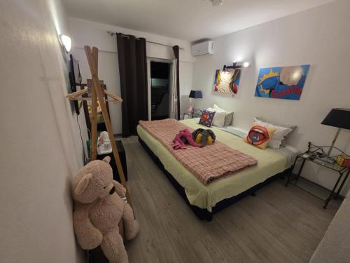 a small bedroom with a bed with a teddy bear at Guest House Casa Ramos on the Strip in Albufeira