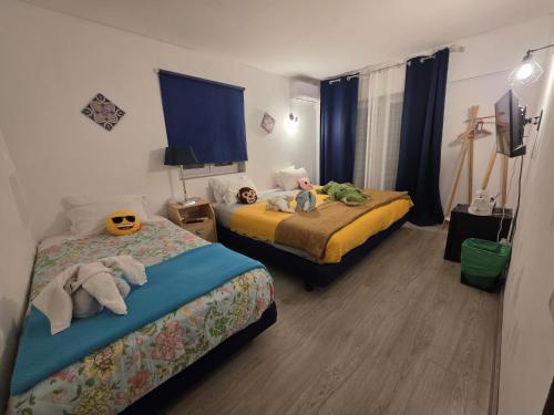a bedroom with two beds with stuffed animals on them at Guest House Casa Ramos on the Strip in Albufeira