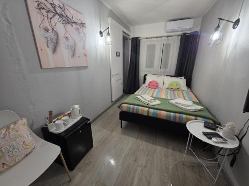 a small room with a bed and a table at Guest House Casa Ramos on the Strip in Albufeira
