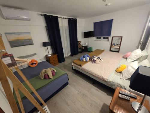 a bedroom with a bed with stuffed animals on it at Guest House Casa Ramos on the Strip in Albufeira