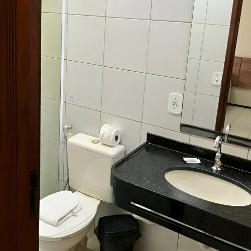 a bathroom with a toilet and a sink at Pousada Lagoa Seca in Juazeiro do Norte