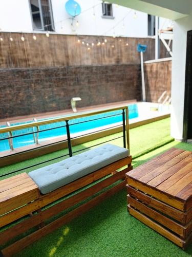 a wooden bench sitting on top of a pool at Boho apartment and spa in Lekki