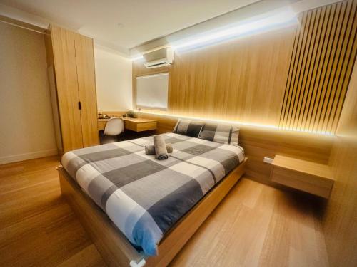 a bedroom with a large bed in a room at Oak Haven Sydney Suites in Sydney