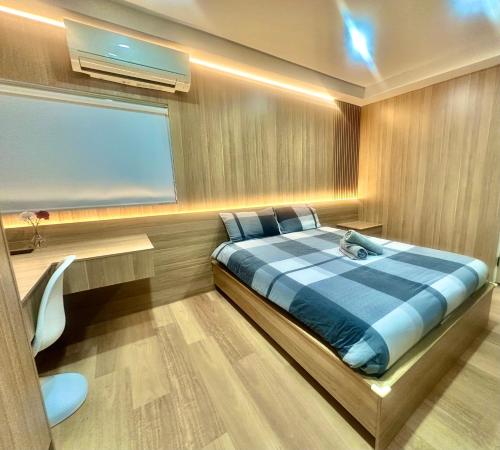 a bedroom with a bed and a desk and a window at Oak Haven Sydney Suites in Sydney