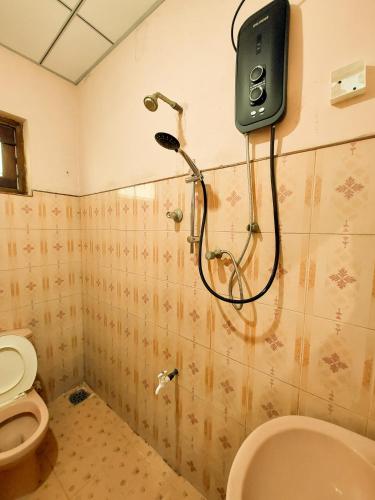 a bathroom with a shower and a toilet at Golden Breeze Villa Bentota in Beruwala