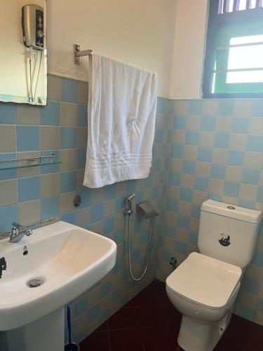 une salle de bain avec des toilettes blanches et un lavabo dans l'établissement Rella Dream, à Matara