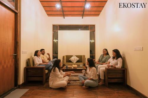 a group of people sitting in front of a mirror at EKOSTAY - Forest Cube Villa in Attigundi