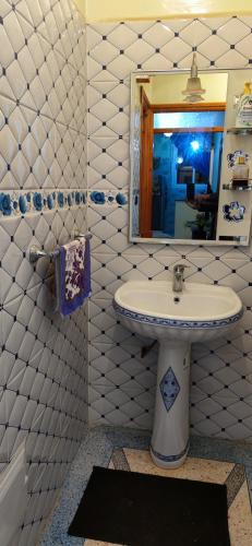 a bathroom with a sink and a mirror at Luxury Guest House in Agadir