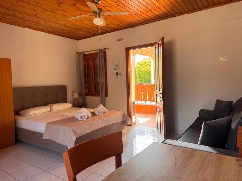 een slaapkamer met een bed en een woonkamer met een bank bij Elia Limnos in Plati