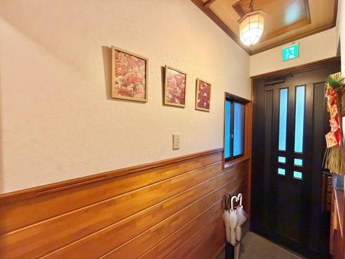 a hallway with wooden floors and a door at Ninja Tokyo Hideaway Higashi-Shinkoiwa in Tokyo