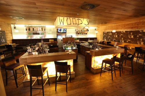 a restaurant with tables and chairs and a fireplace at Stammhaus im Hotel Alpine Palace in Saalbach Hinterglemm