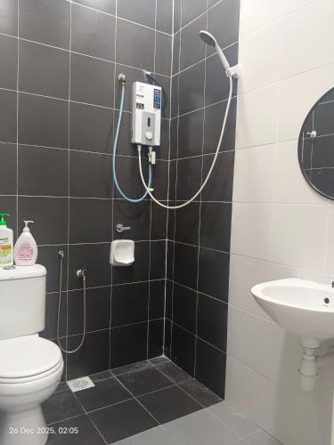 a bathroom with a toilet and a sink at Halia Homestay in Batu Pahat