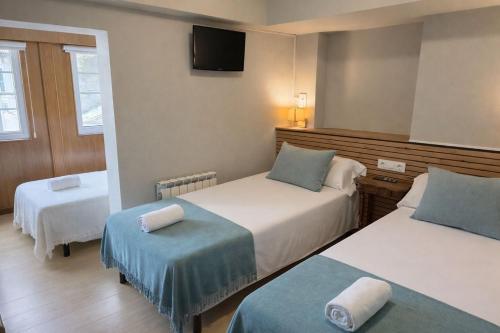 Postel nebo postele na pokoji v ubytování Hotel Real