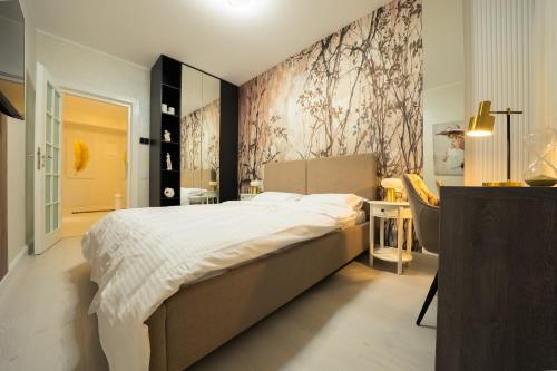 a bedroom with a bed and a wall with flowers at Royal Luxury Suite in Iaşi