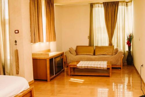 a living room with a couch and a table at Nathay Hotel in Addis Ababa Bole International Airport