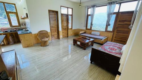 a living room with a couch and a table at The Himalayan Castle View Retreat in Nagar