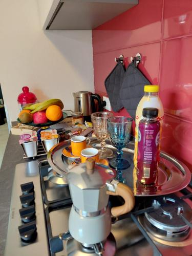 a kitchen counter with a stove with a tea pot and dishes at Novecento in Bertinoro