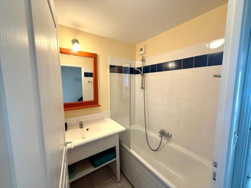 a bathroom with a sink and a shower and a mirror at Studio face à l océan in Les Sables-d'Olonne