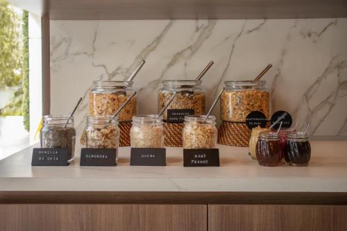 a shelf with jars of granola on a counter at Binn Hotel in Medellín