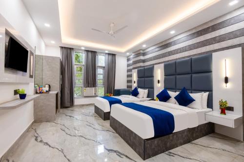 a hotel room with two beds and a television at Hotel MSRegency At Karol Bagh in New Delhi