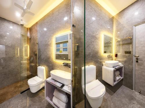 a bathroom with two toilets and a shower at Hotel MSRegency At Karol Bagh in New Delhi