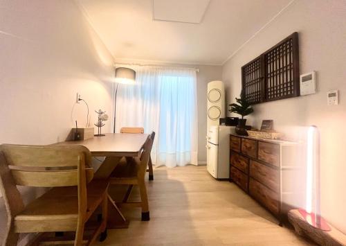 une cuisine et une salle à manger avec une table et un réfrigérateur dans l'établissement Kintex Golden Stay, 