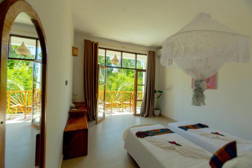 Postel nebo postele na pokoji v ubytování Sky & Sand Zanzibar