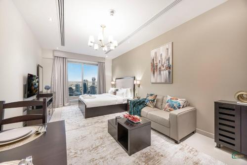 a living room with a couch and a bed at Spacious & cozy Studio in Downtown! in Sabkhah