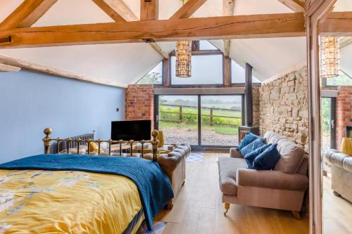 a bedroom with a bed and a couch and a tv at 1 Bed in Wheathill oc-t29765 in Loughton