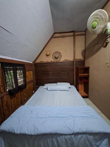 a bedroom with a large bed in a room at Raya Homestay Rammang Rammang in Kasijala