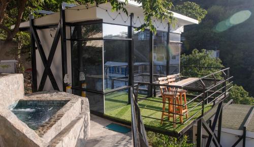 vue extérieure d'une maison en verre avec piscine dans l'établissement Villa Malibu, à Taganga