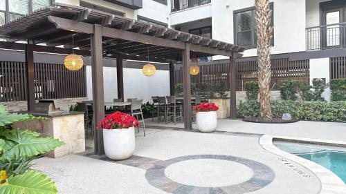 a patio with a pergola and a swimming pool at Relaxing Pool-View 1BR Near Top Houston Spots in Houston
