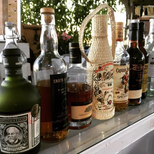 a group of bottles of alcohol sitting on a shelf at Sydkustens at Pillehill in Skivarp