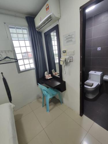 a bathroom with a sink and a toilet at comfortpahlawan in Sibu