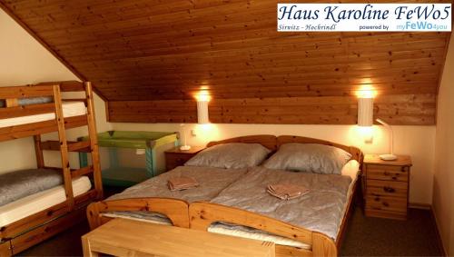 a bedroom with a bed and two bunk beds at Haus Karoline FeWo5 in Hochrindl