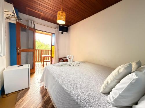 En eller flere senge i et værelse på Pousada Refugio dos Palmares