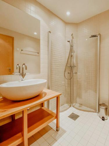 a bathroom with a sink and a shower at Charming Cabin Overlooking Vegglifjell in Kravikfjord